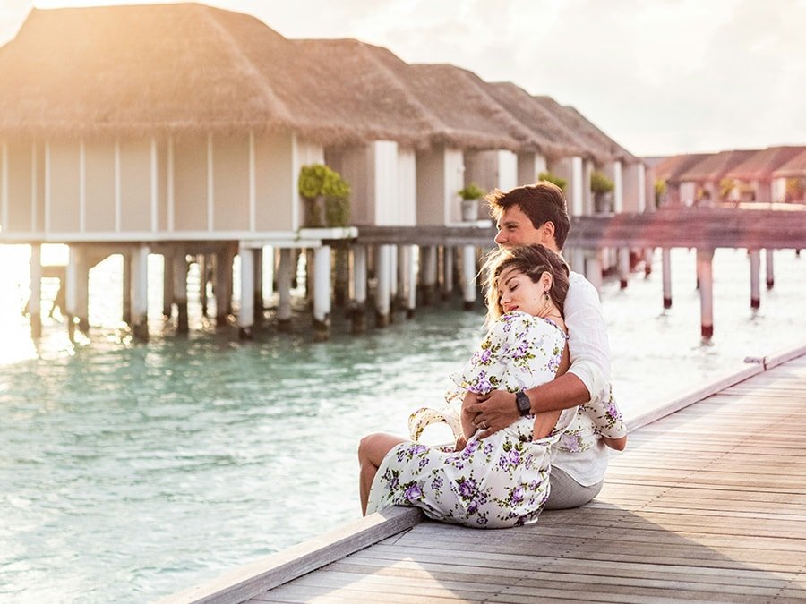 A couple sitting on a dock
